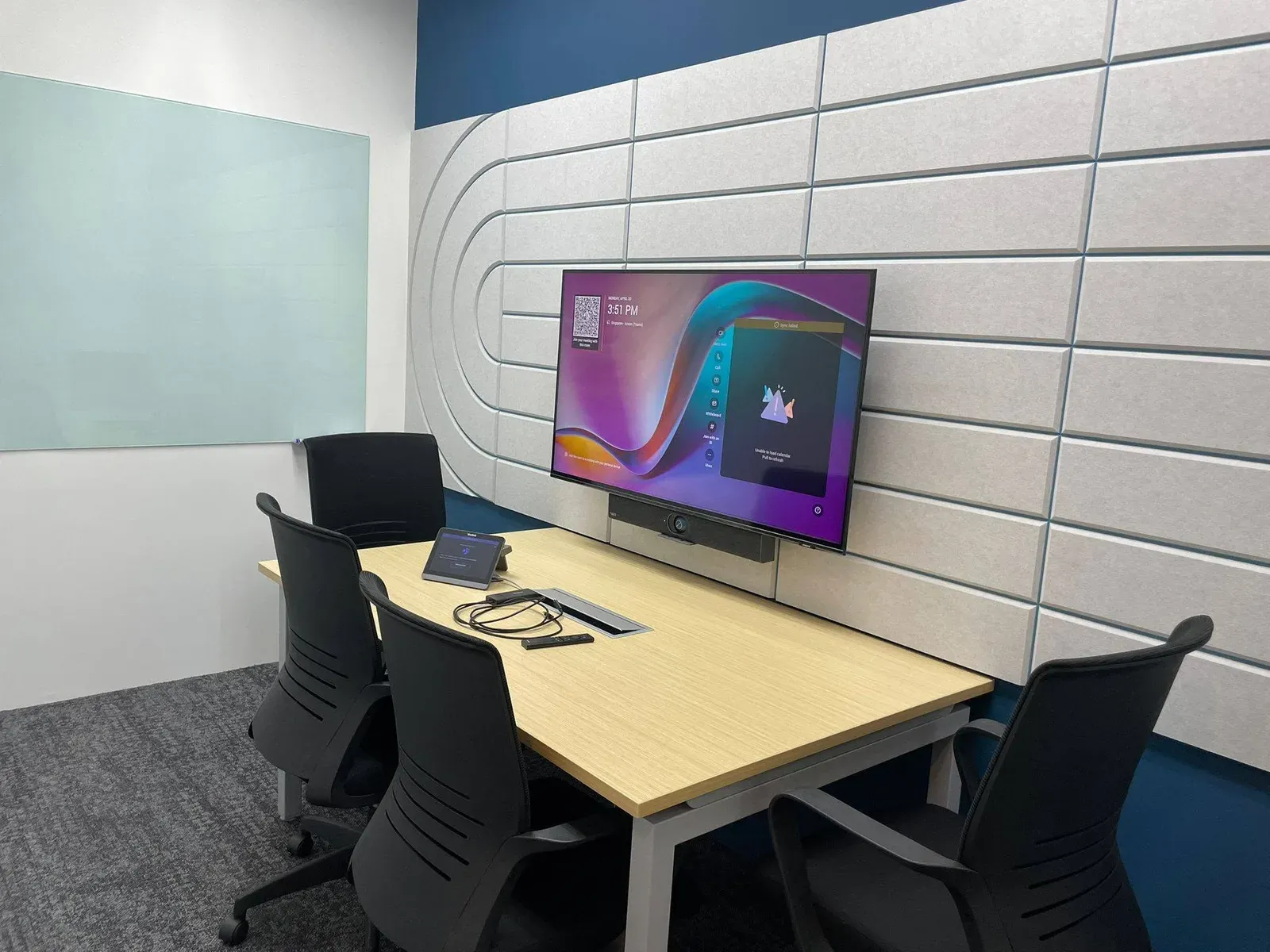 Huddle room with a wall display, video bar and table touch panel, installed by VisionCast