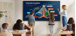 Children and a teacher working on a volcano diagram at a Samsung WAF display in a classroom